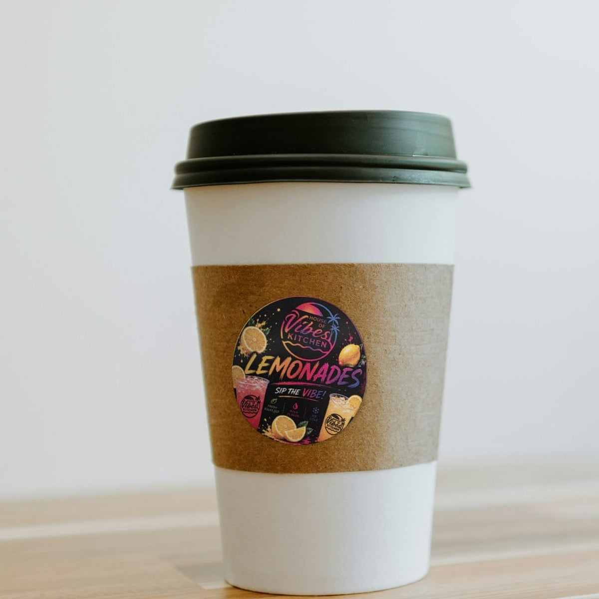 Custom circle sticker on a coffee cup sleeve