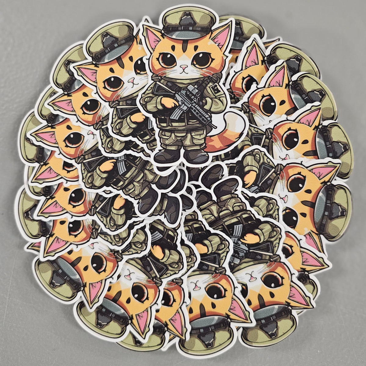 Pile of die cut stickers of a cartoon cat in army gear