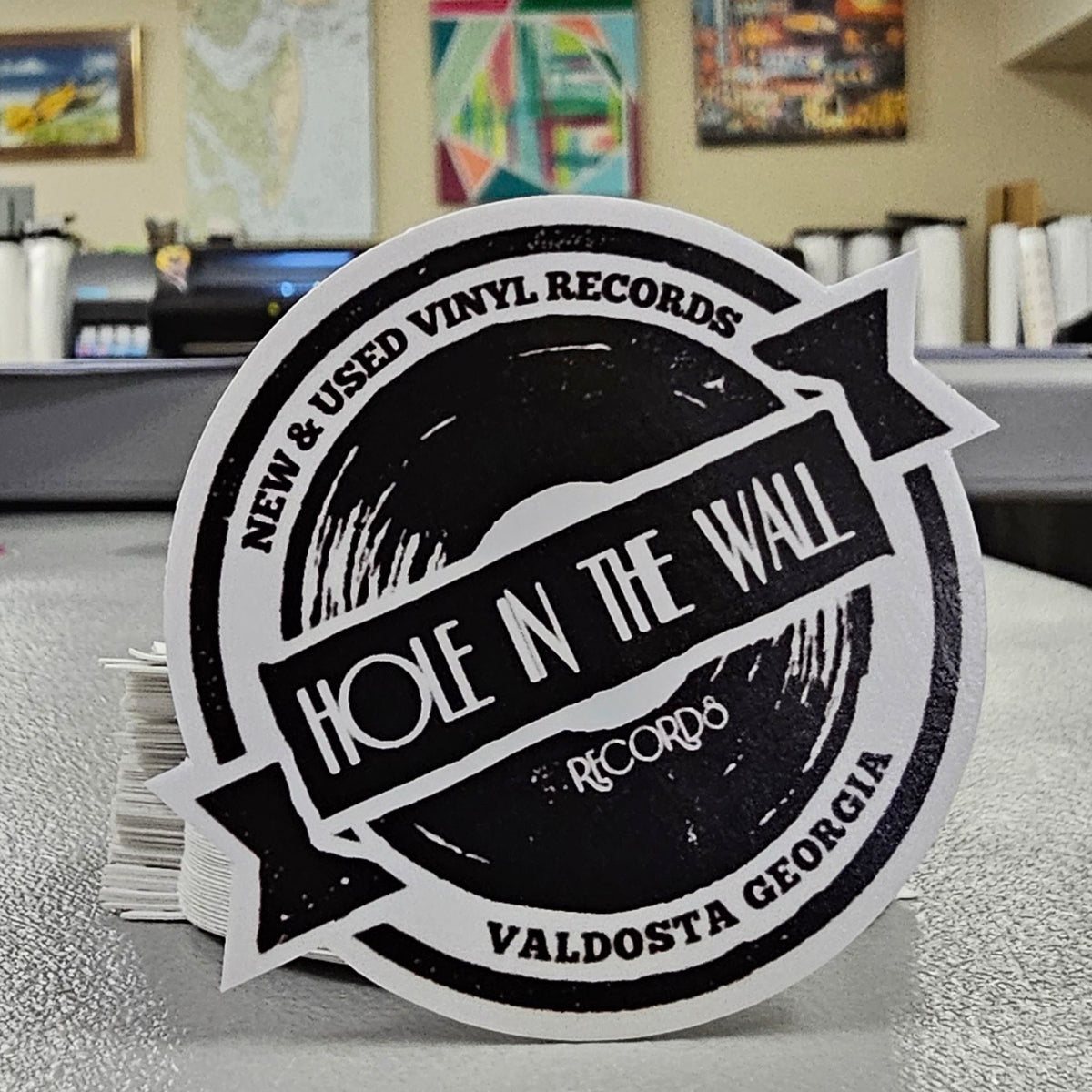 Round Hole in the Wall Records logo sticker from Valdosta, Georgia, standing on a shop counter